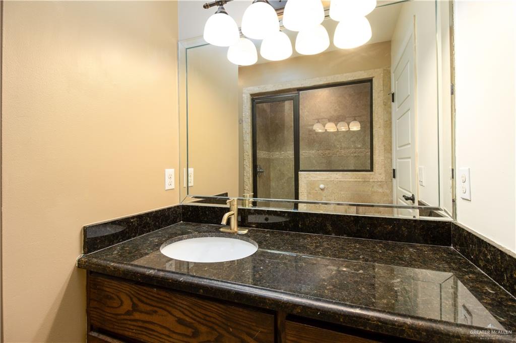 8907 North 36th Lane McAllen, TX 78504 - Photo 10 of 16 a bathroom with a sink and a mirror