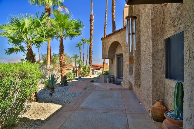 a house with potted plants in front of it