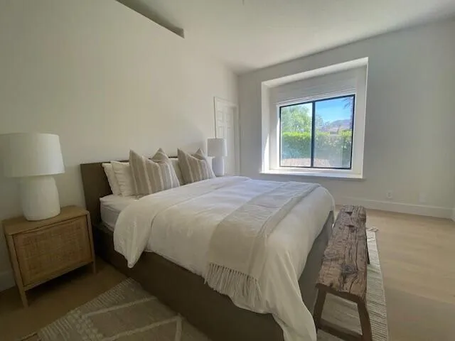 a bedroom with a bed and window