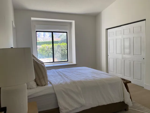a bedroom with a bed and window