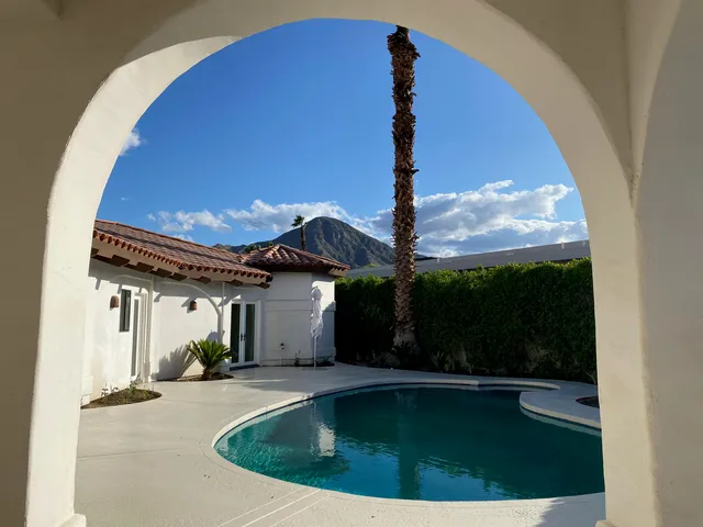 a view of a house with backyard porch and sitting area