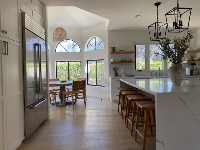 a view of dining room and kitchen with furniture large window and wooden floor