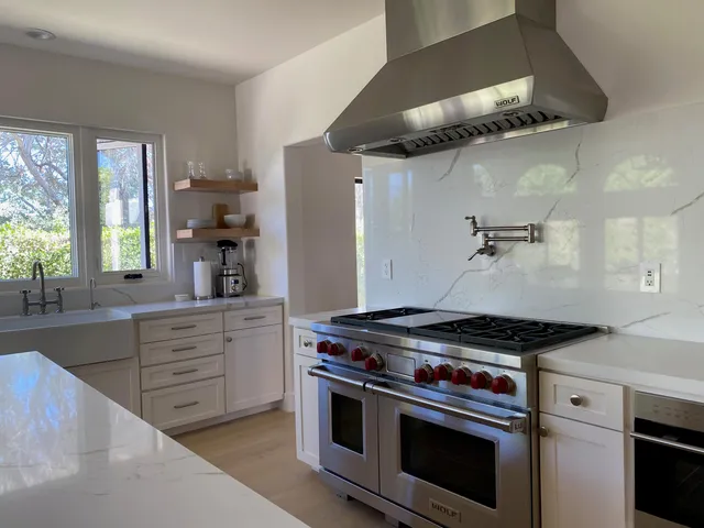 a kitchen with stainless steel appliances granite countertop a stove and a sink