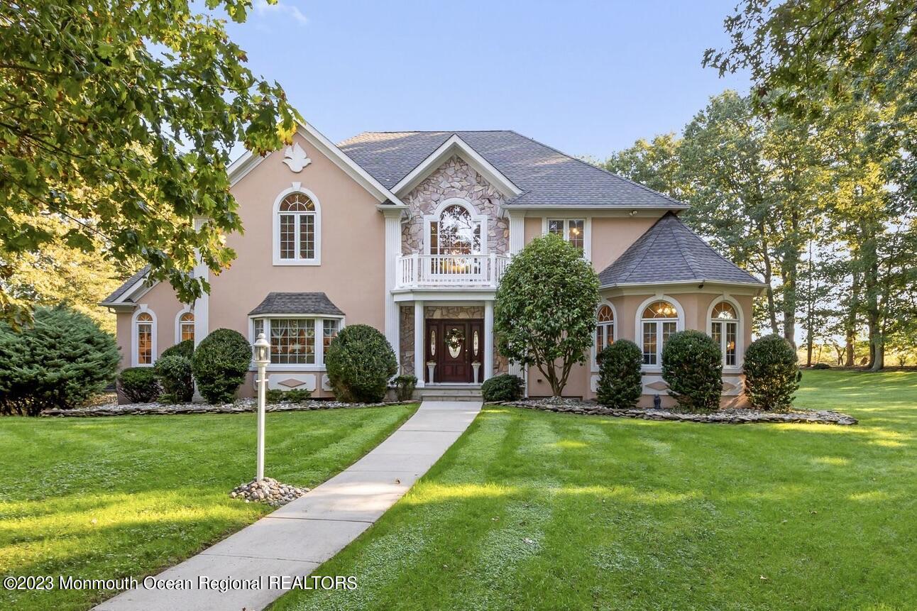 1841 Celeste Drive Wall, NJ 07719 - Photo 1 of 107 a front view of a house with a yard and garage