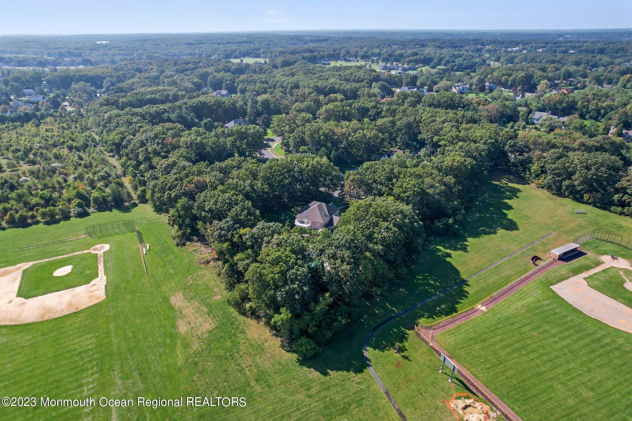 1841 Celeste Drive Wall, NJ 07719 - Photo 104 of 107 an aerial view of green landscape with trees houses and mountain view