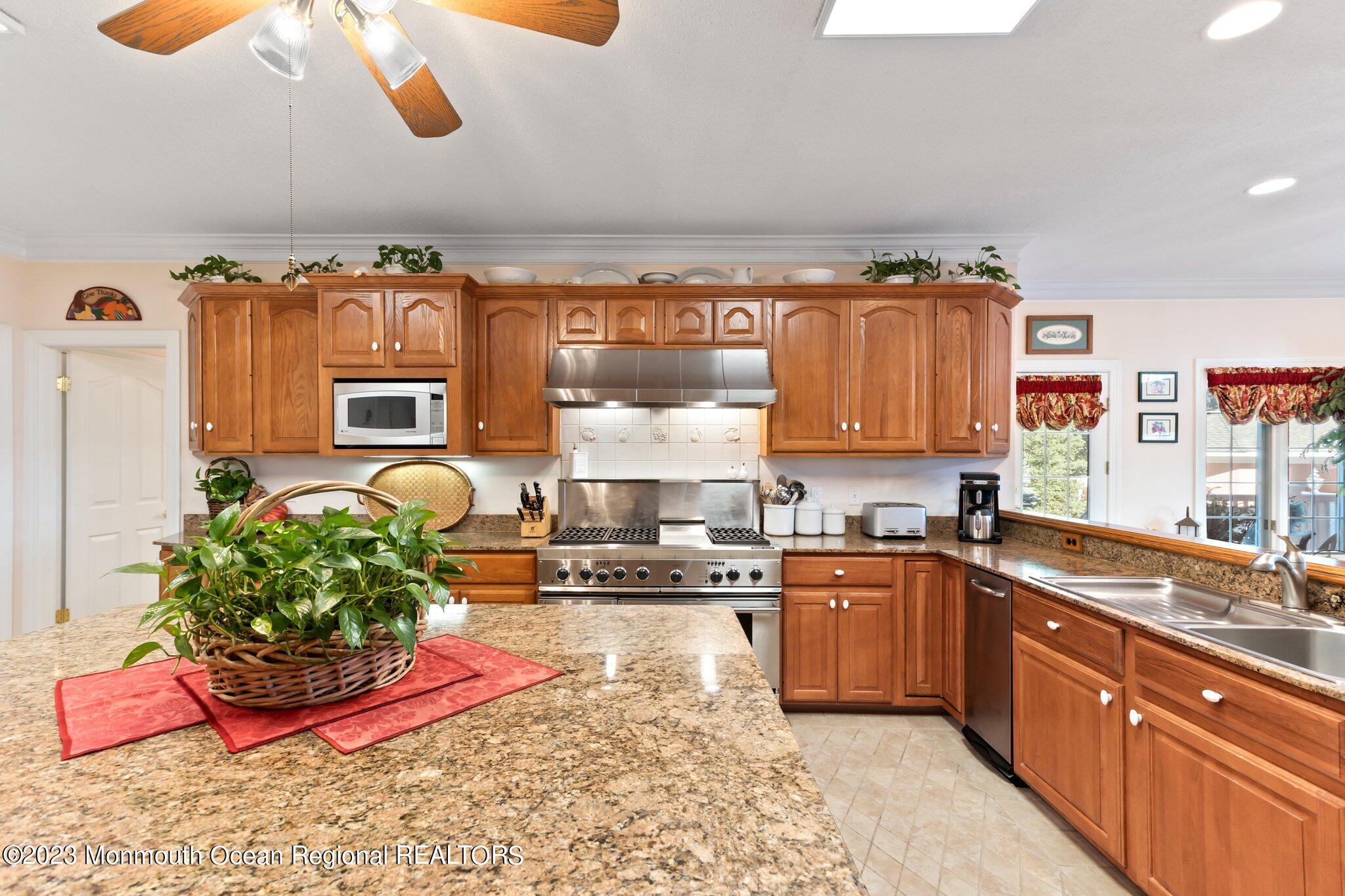 1841 Celeste Drive Wall, NJ 07719 - Photo 21 of 107 a large kitchen with stainless steel appliances granite countertop a stove a sink and a granite counter tops