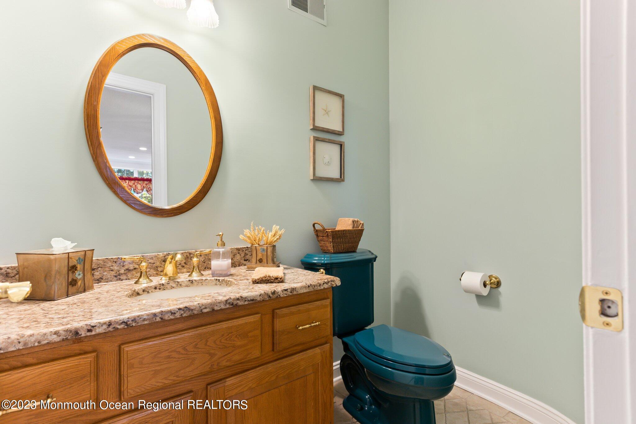 1841 Celeste Drive Wall, NJ 07719 - Photo 30 of 107 a bathroom with a granite countertop toilet a sink and a mirror