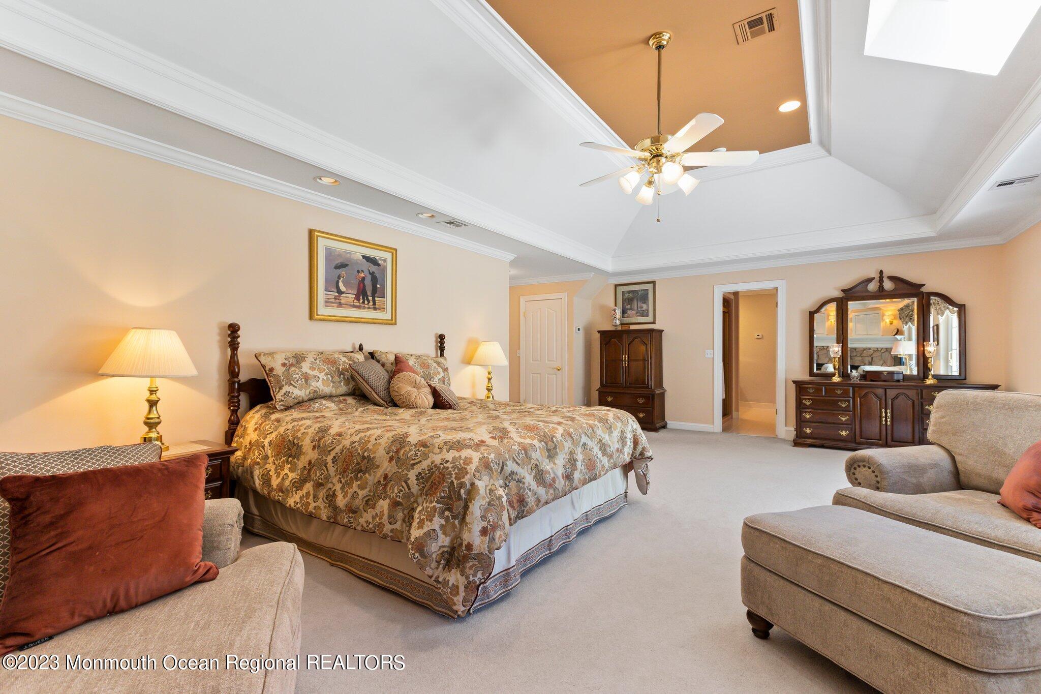 1841 Celeste Drive Wall, NJ 07719 - Photo 36 of 107 a spacious bedroom with a bed couch chandelier and a window