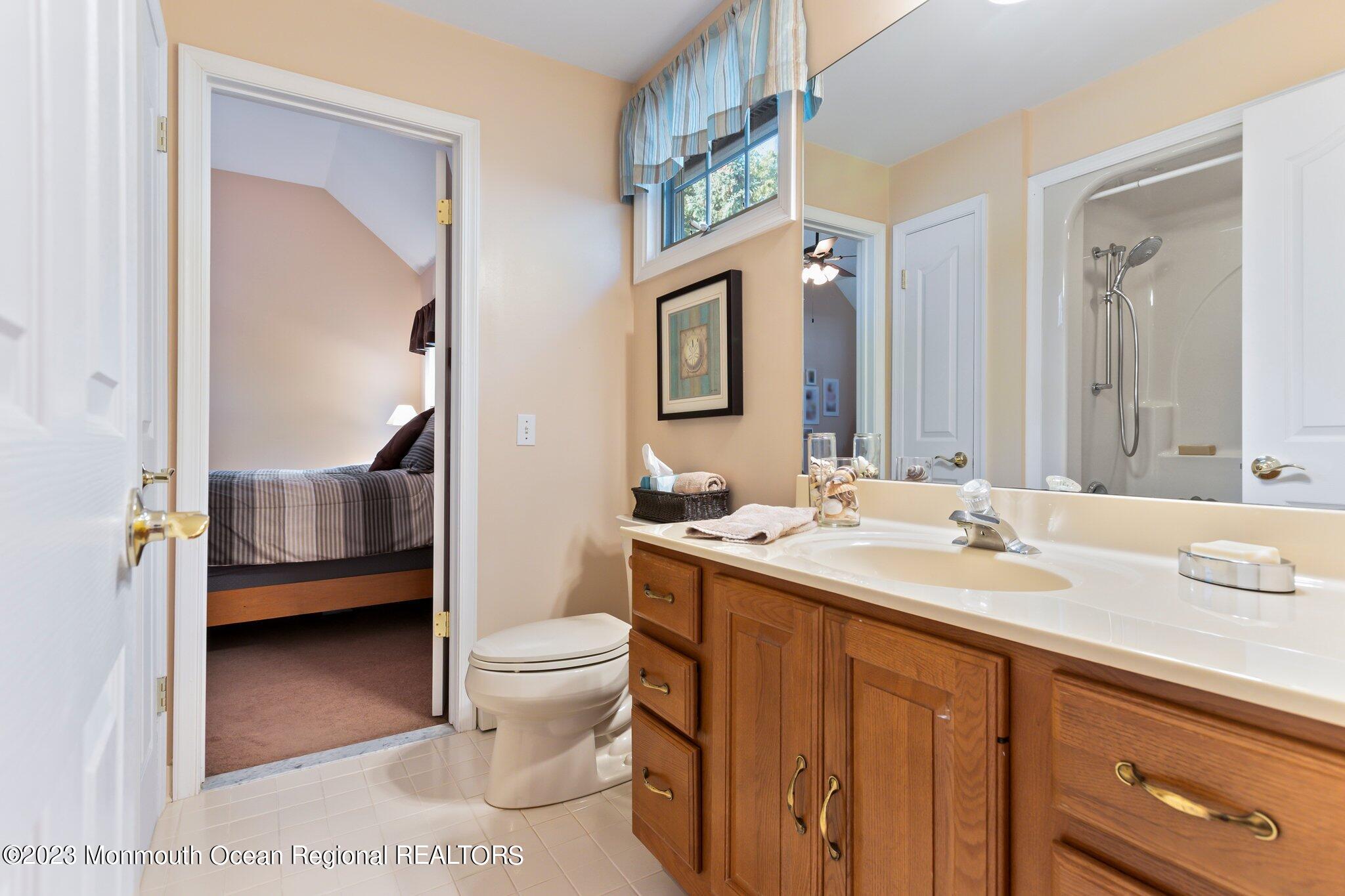 1841 Celeste Drive Wall, NJ 07719 - Photo 45 of 107 a en suite bathroom with a sink a toilet and a large mirror