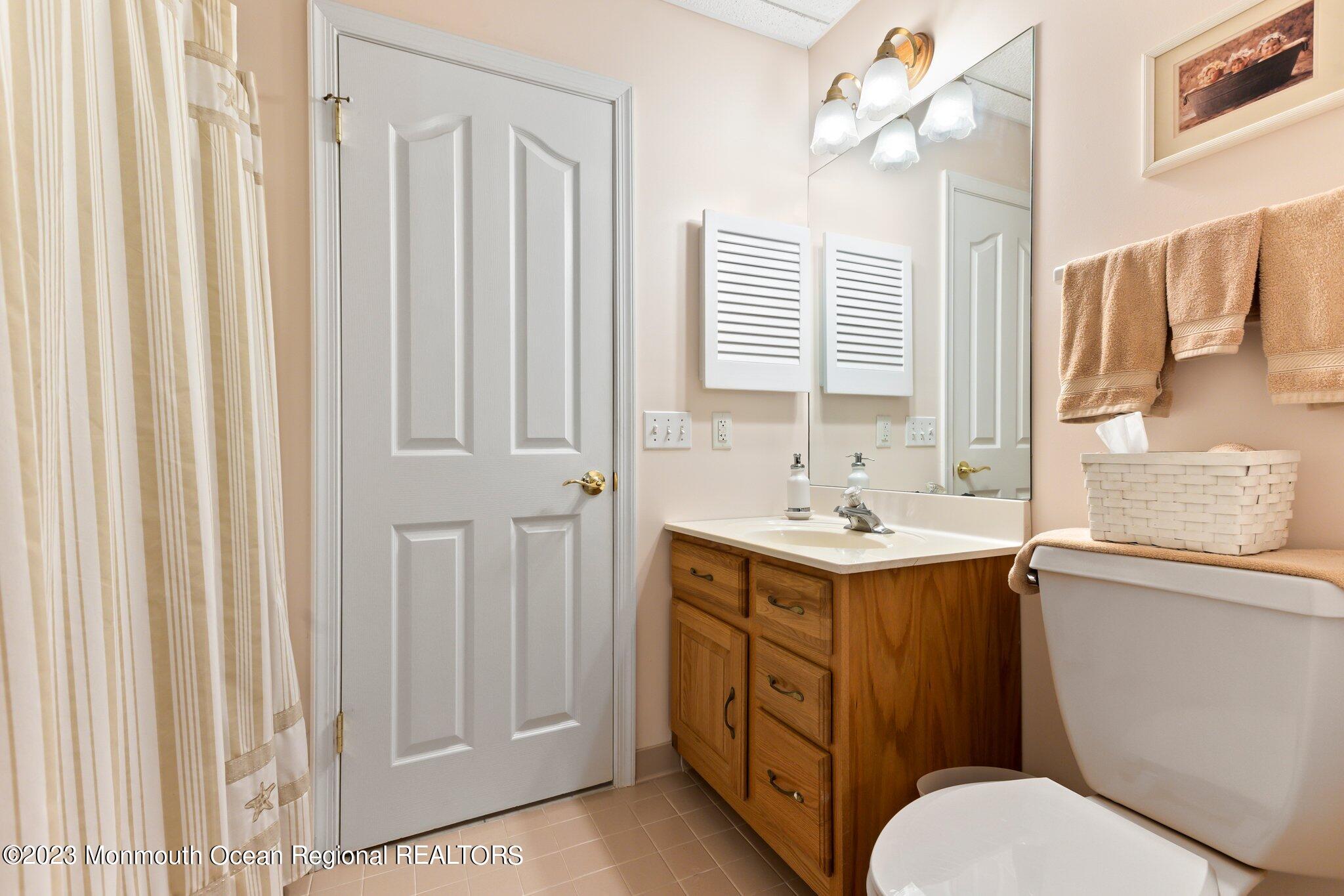 1841 Celeste Drive Wall, NJ 07719 - Photo 60 of 107 a bathroom with a sink a toilet and a mirror