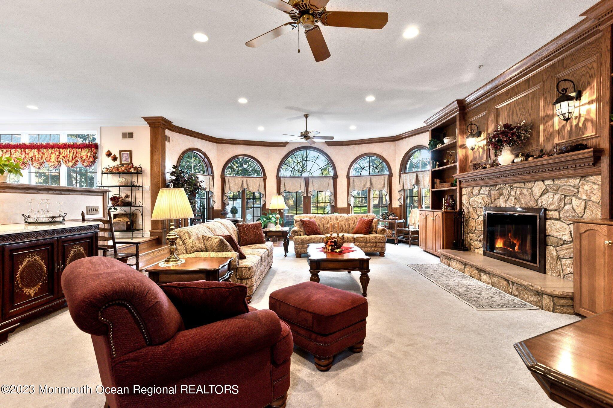 1841 Celeste Drive Wall, NJ 07719 - Photo 6 of 107 a living room with furniture a fireplace and a floor to ceiling window