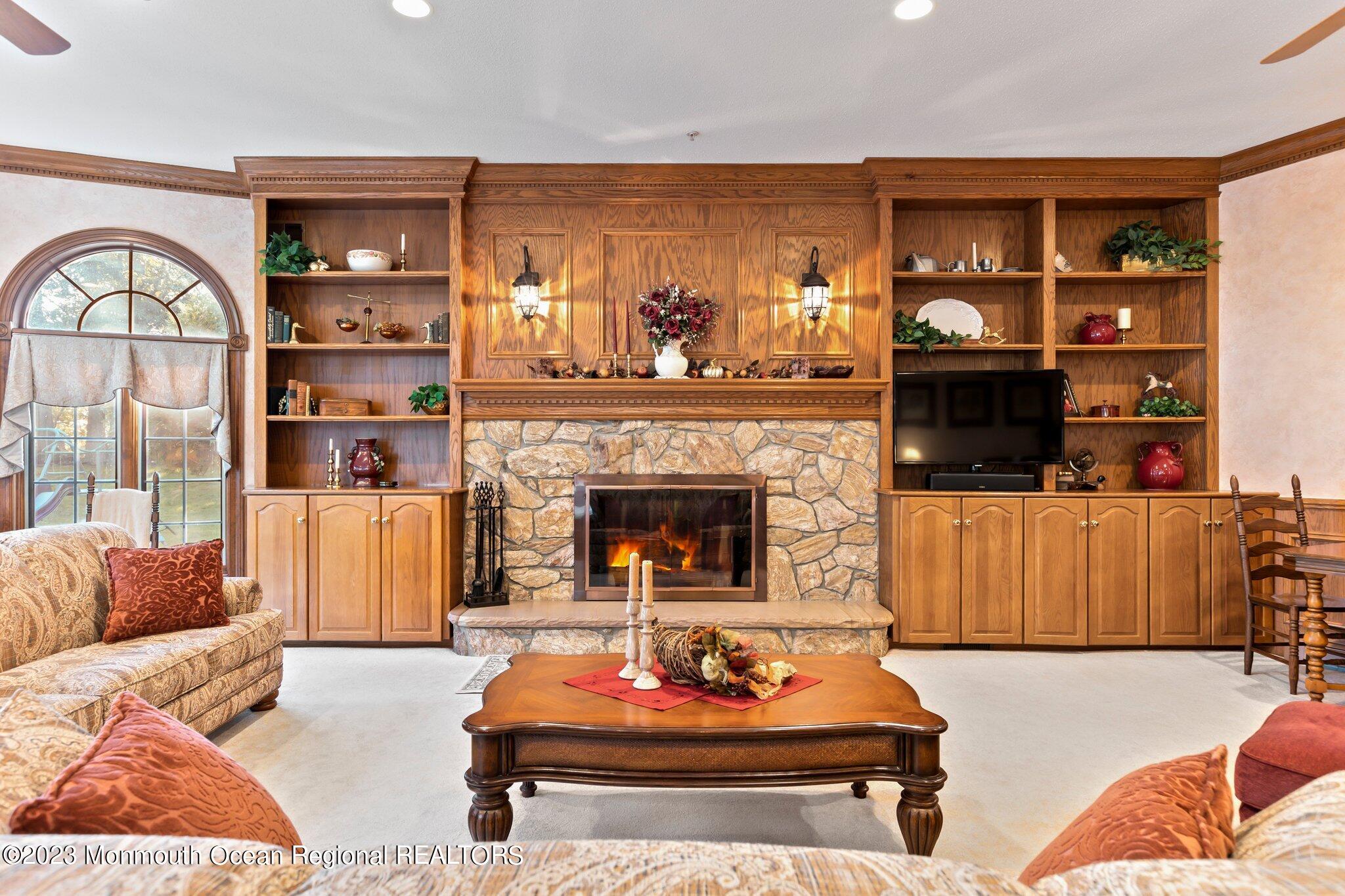 1841 Celeste Drive Wall, NJ 07719 - Photo 7 of 107 a living room with furniture a rug and a fireplace