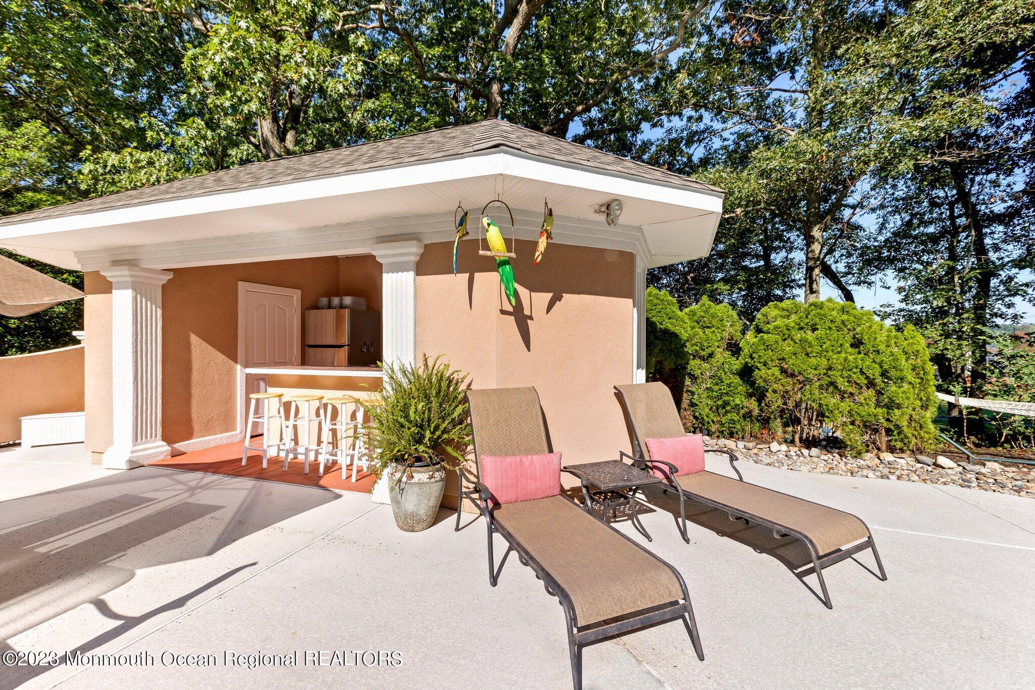 1841 Celeste Drive Wall, NJ 07719 - Photo 85 of 107 a view of a patio with table and chairs and potted plants