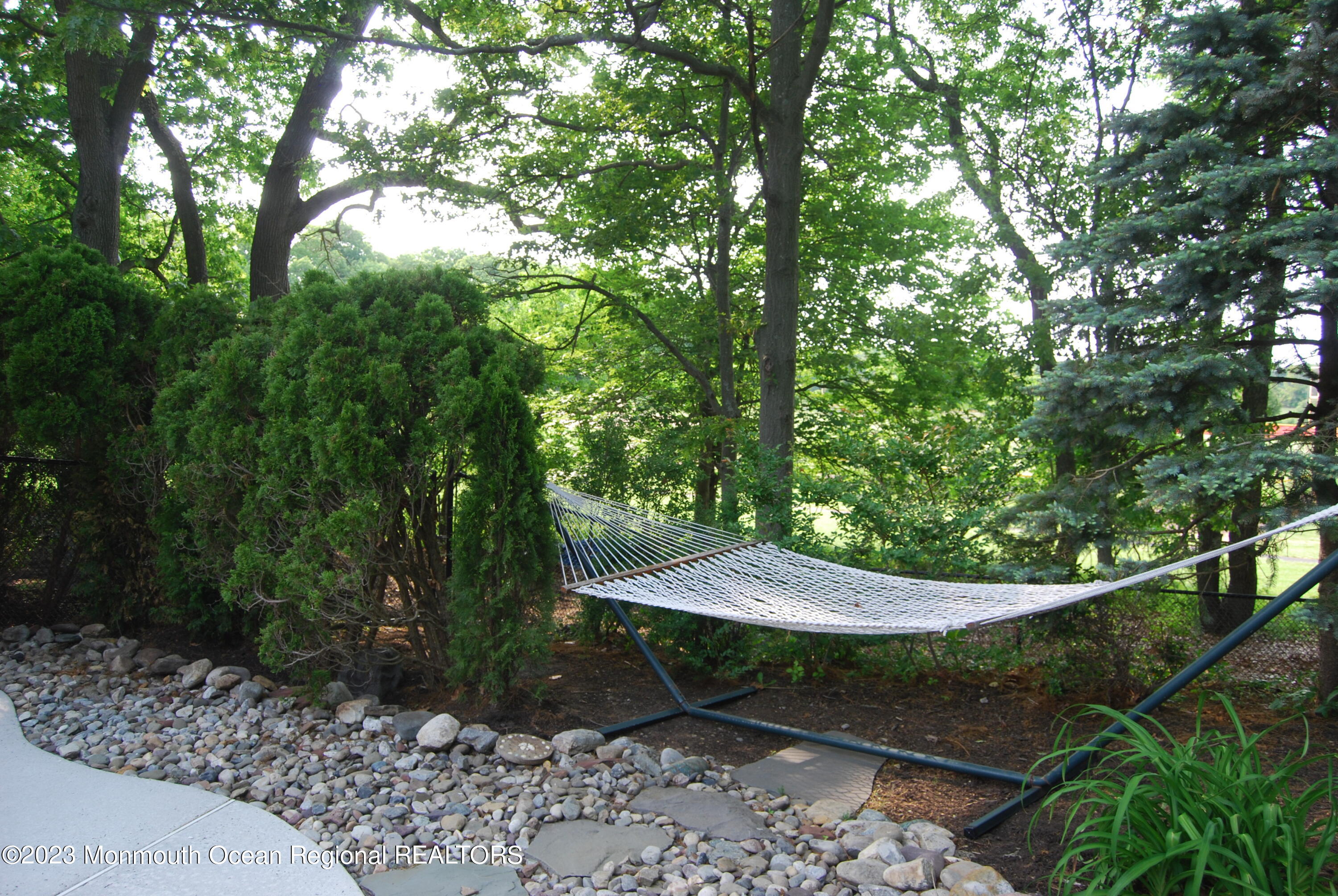 1841 Celeste Drive Wall, NJ 07719 - Photo 94 of 107 a view of a backyard with potted plants and large trees