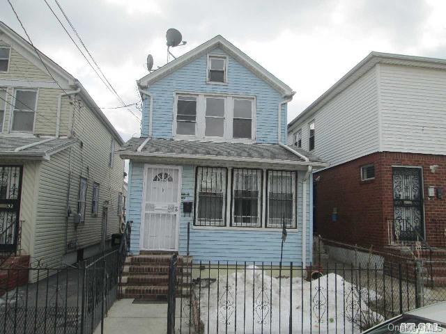 171-30 103rd Road Queens, NY 11433 - Photo 1 of 1 a front view of a house with a garden