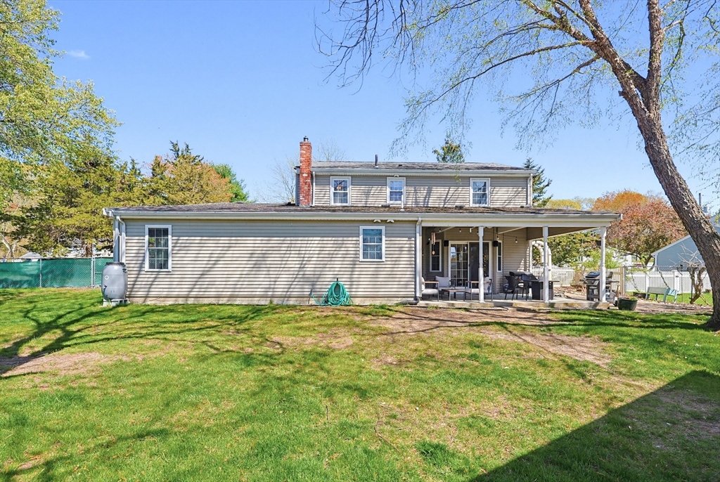 18 Anchorage Road Franklin, MA 02038 - Photo 39 of 42 a front view of a house with a yard table and chairs