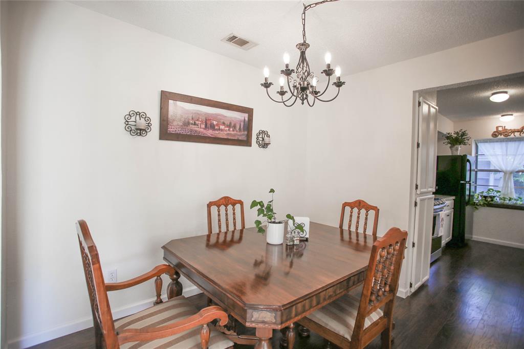 1720 Crystal Way Plano, TX 75074 - Photo 9 of 32 a view of a dining room with furniture wooden floor and chandelier