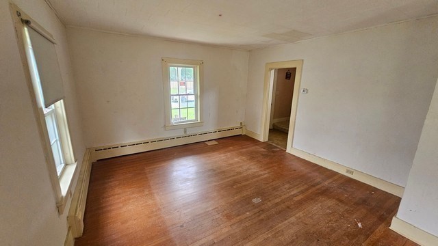 58 Ruggles Street Hardwick, MA 01031 - Photo 11 of 18 an empty room with wooden floor and windows