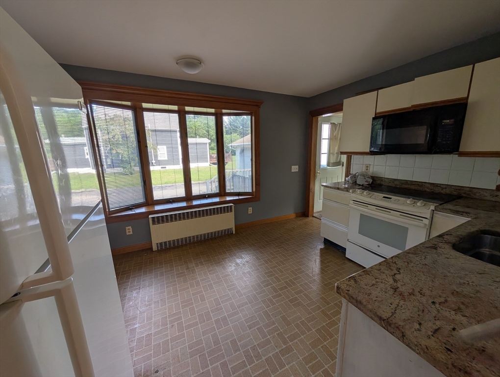 58 Ruggles Street Hardwick, MA 01031 - Photo 7 of 18 a living room with stainless steel appliances furniture and a flat screen tv