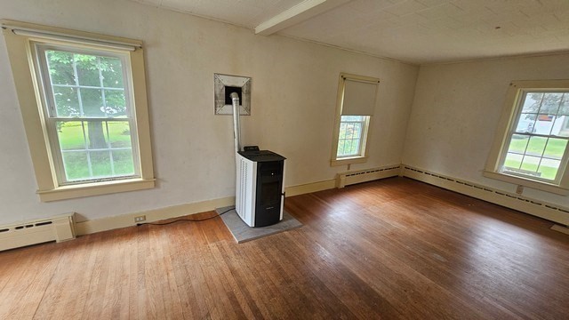 58 Ruggles Street Hardwick, MA 01031 - Photo 8 of 18 a view of an empty room with wooden floor and a window