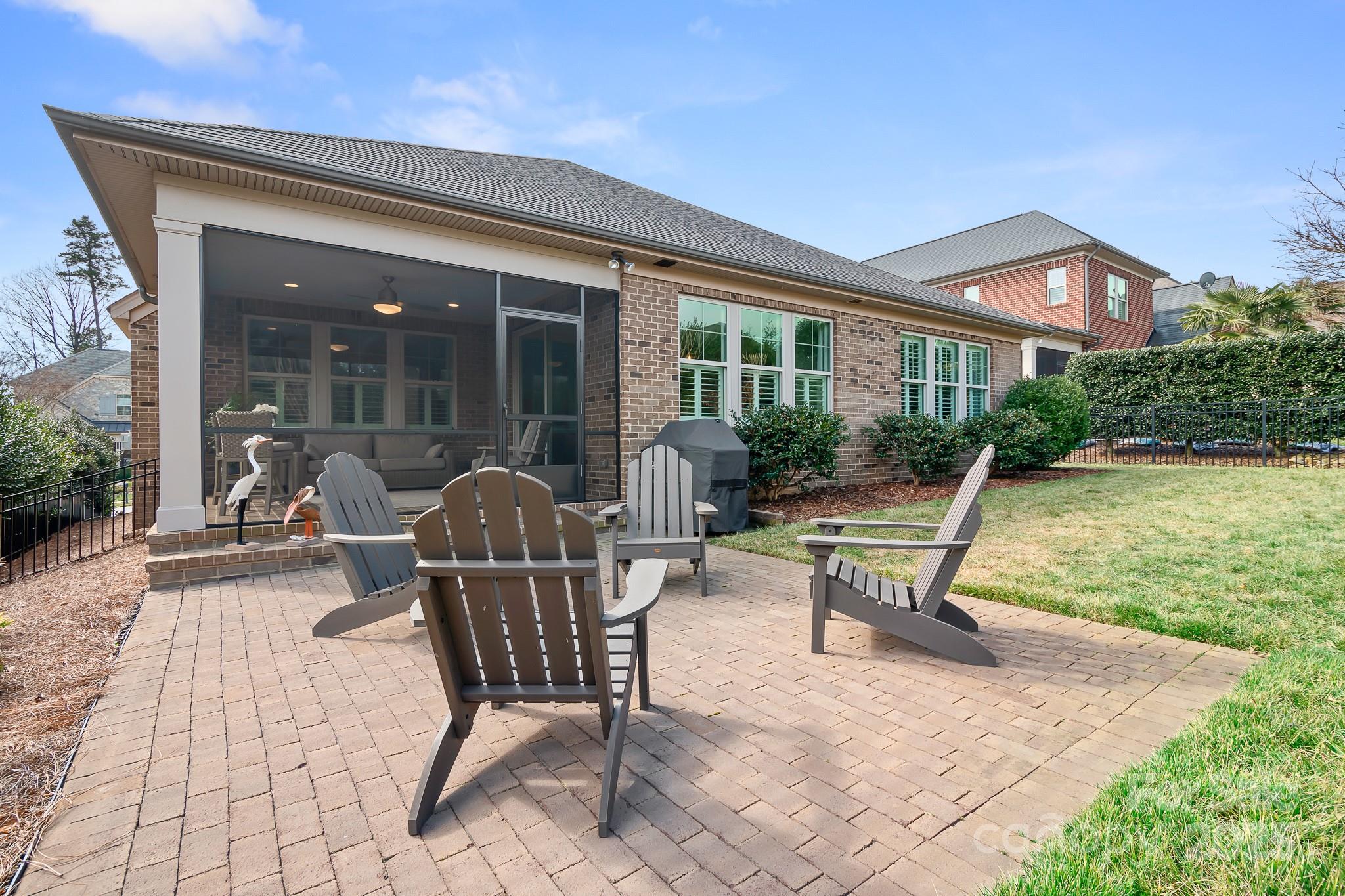 9223 Robbins Preserve Road Cornelius, NC 28031 - Photo 11 of 38 a patio with a table and chairs and potted plants