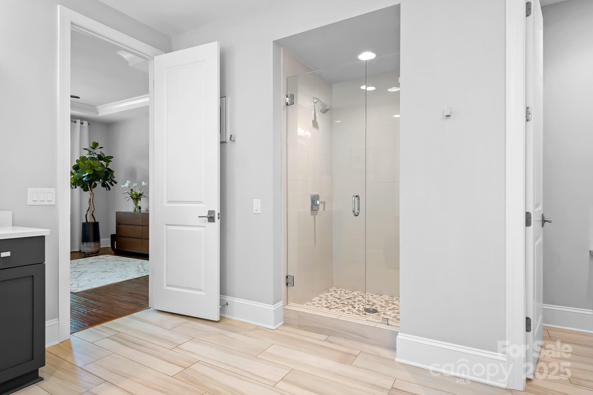 9223 Robbins Preserve Road Cornelius, NC 28031 - Photo 17 of 38 a view of a hallway with wooden floor and a bathroom