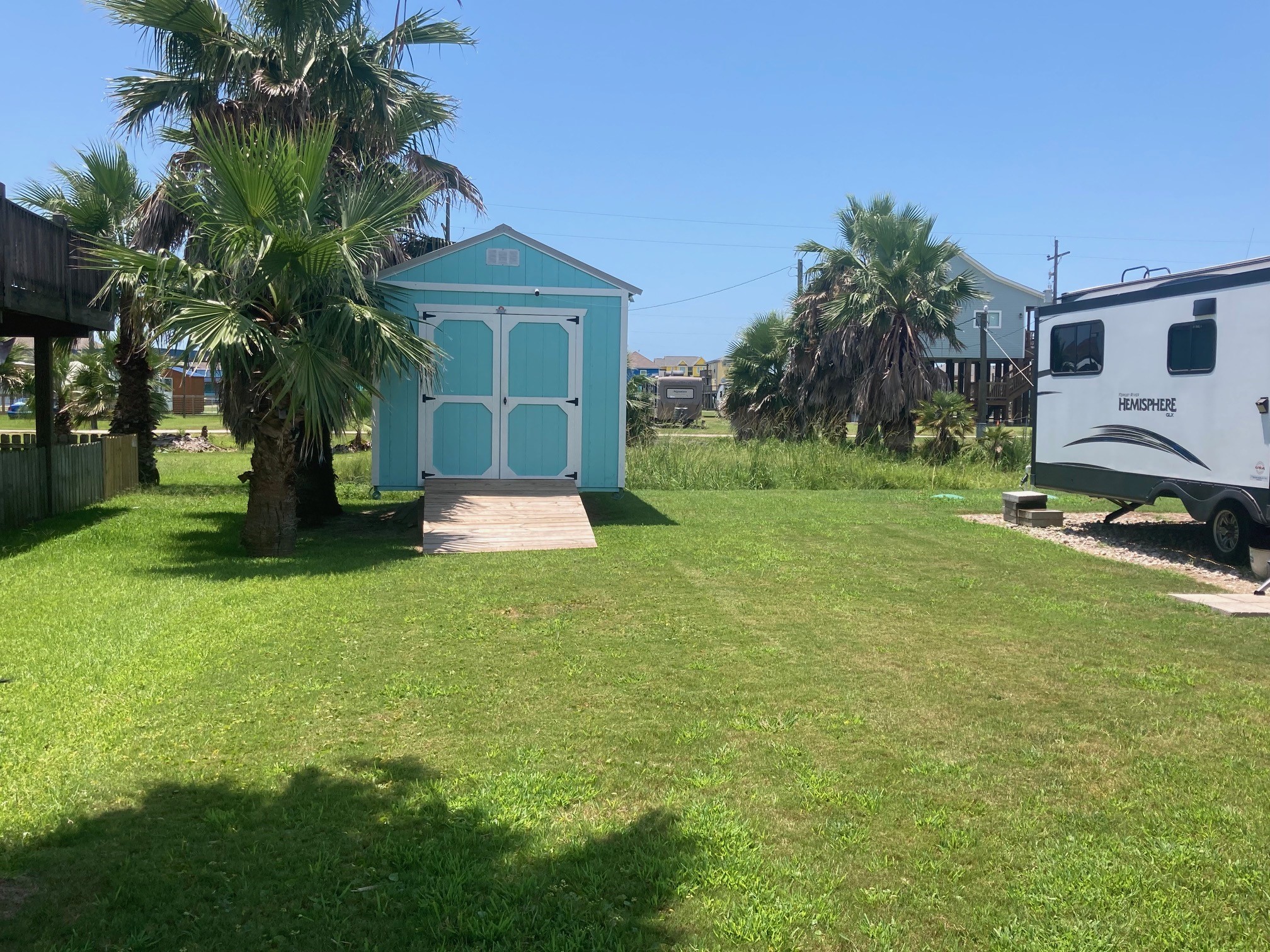 108 Mae Circle Crystal Beach, TX 77650 - Photo 13 of 22 a view of a backyard with a garden and entertaining space