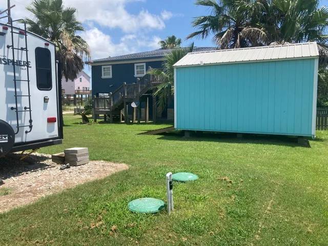 a view of a house with backyard and a tree