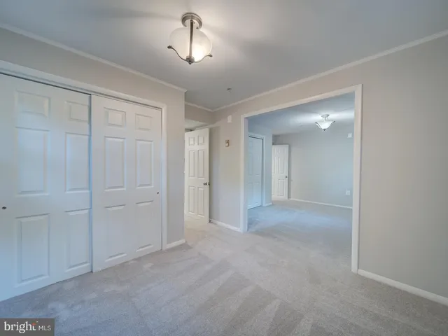 a room with white cabinets and white appliances