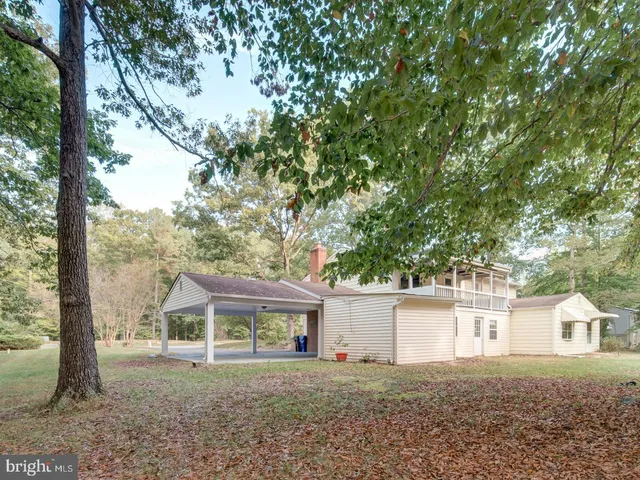a view of an empty room and chandelier fan