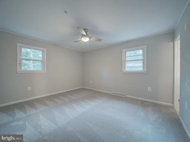 a room with white cabinets and white appliances