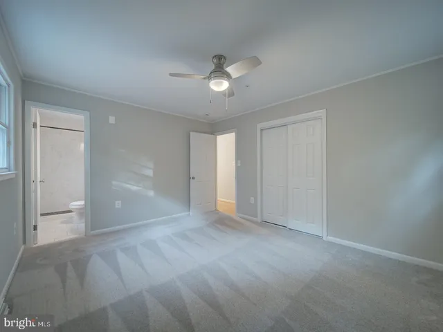 a view of a kitchen with white cabinets
