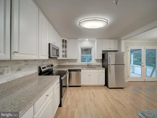 a kitchen with a refrigerator sink and stove