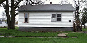 1220 Ave A Rochelle, IL 61068 - Photo 1 of 1 a white house that has tree in front of it