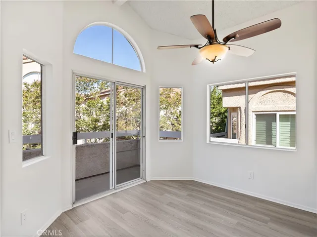 a view of a living room with furniture and a wooden floor