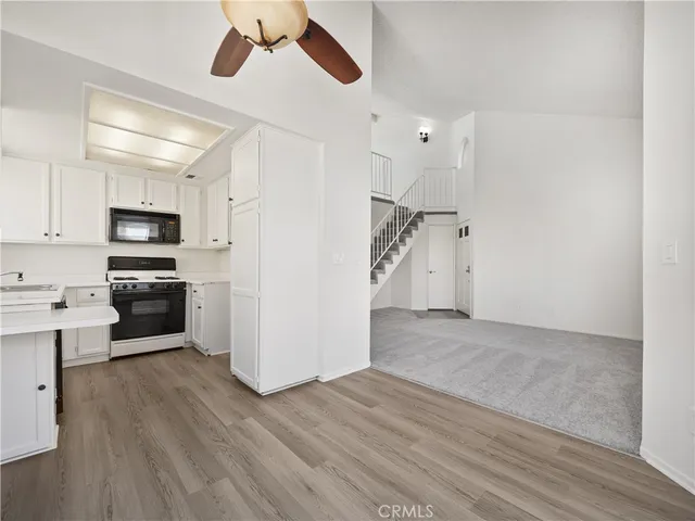 a view of a hallway with wooden floor and closet