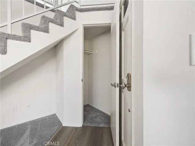 a view of an empty room with a fireplace and a window
