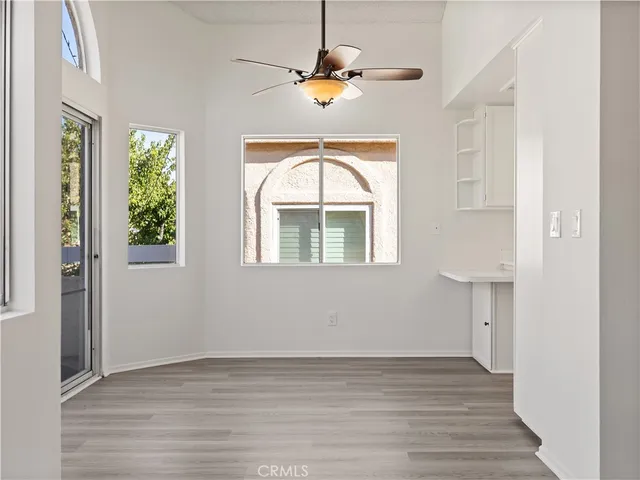 a view of wooden floor and a chandelier in a room