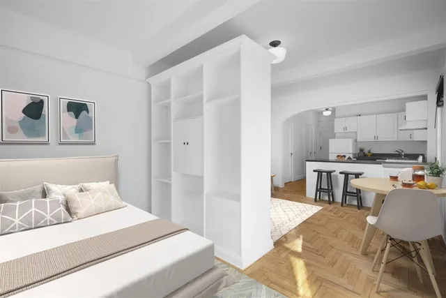 a bedroom with a bed and a view of kitchen