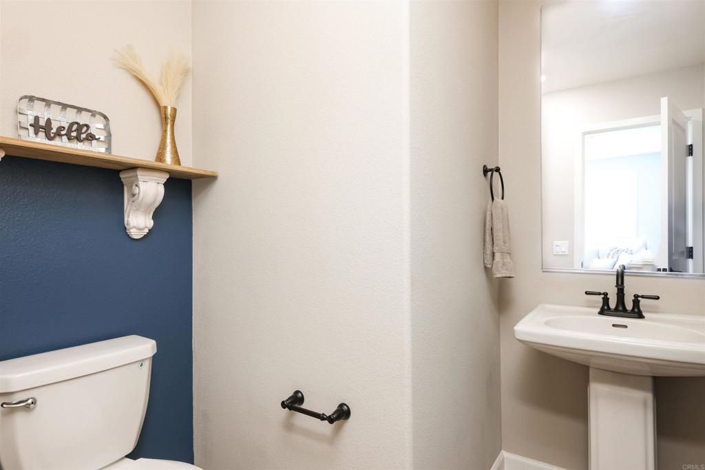 1112 Delpy View Point Vista, CA 92084 - Photo 17 of 62 a bathroom with a sink a mirror and toilet