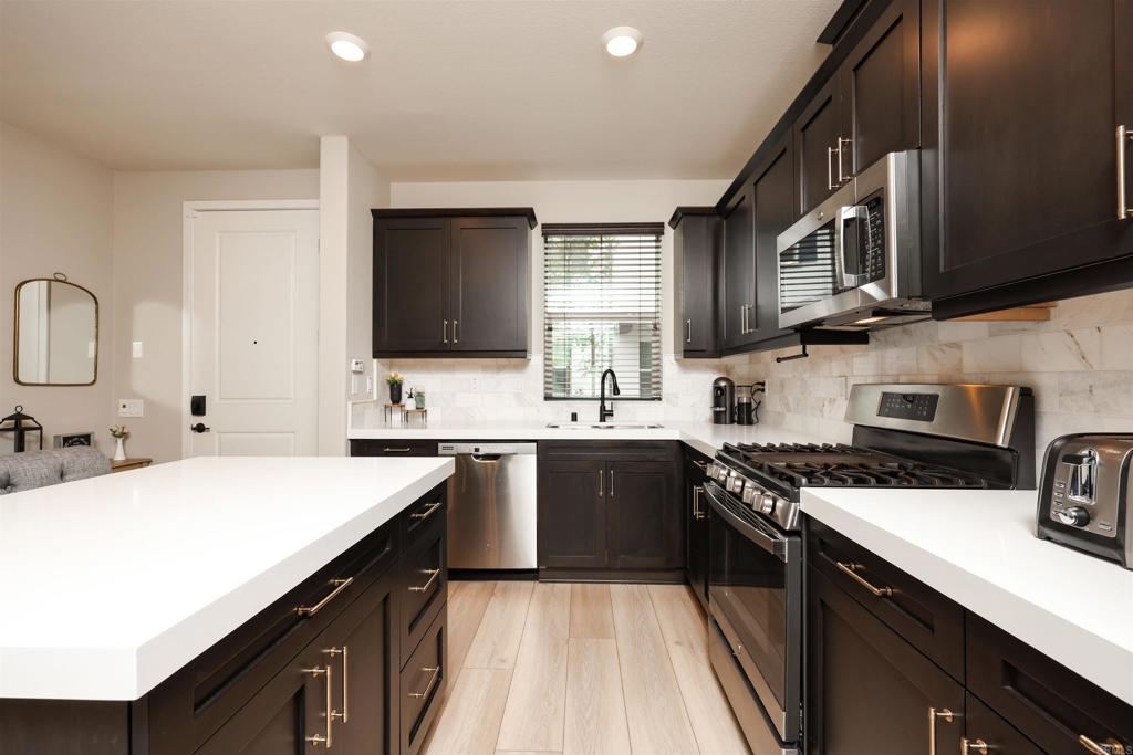 1112 Delpy View Point Vista, CA 92084 - Photo 2 of 62 a kitchen with stainless steel appliances a sink stove top oven and cabinets