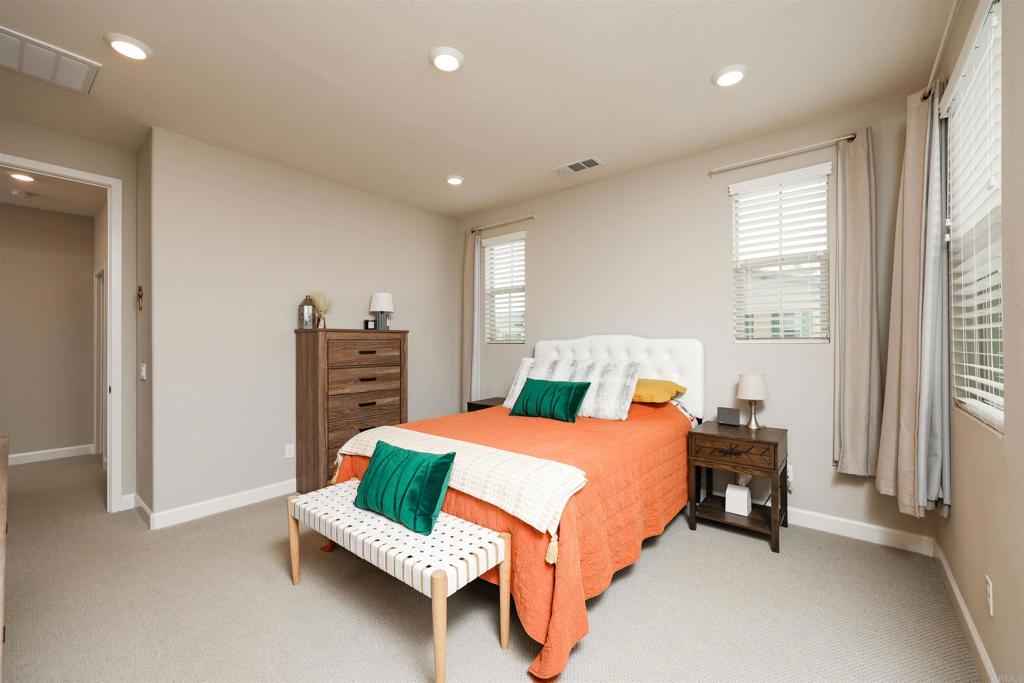 1112 Delpy View Point Vista, CA 92084 - Photo 22 of 62 a bedroom with a bed and a couch