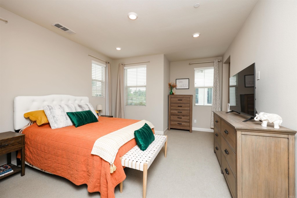 1112 Delpy View Point Vista, CA 92084 - Photo 23 of 62 a bedroom with a bed and a flat screen tv