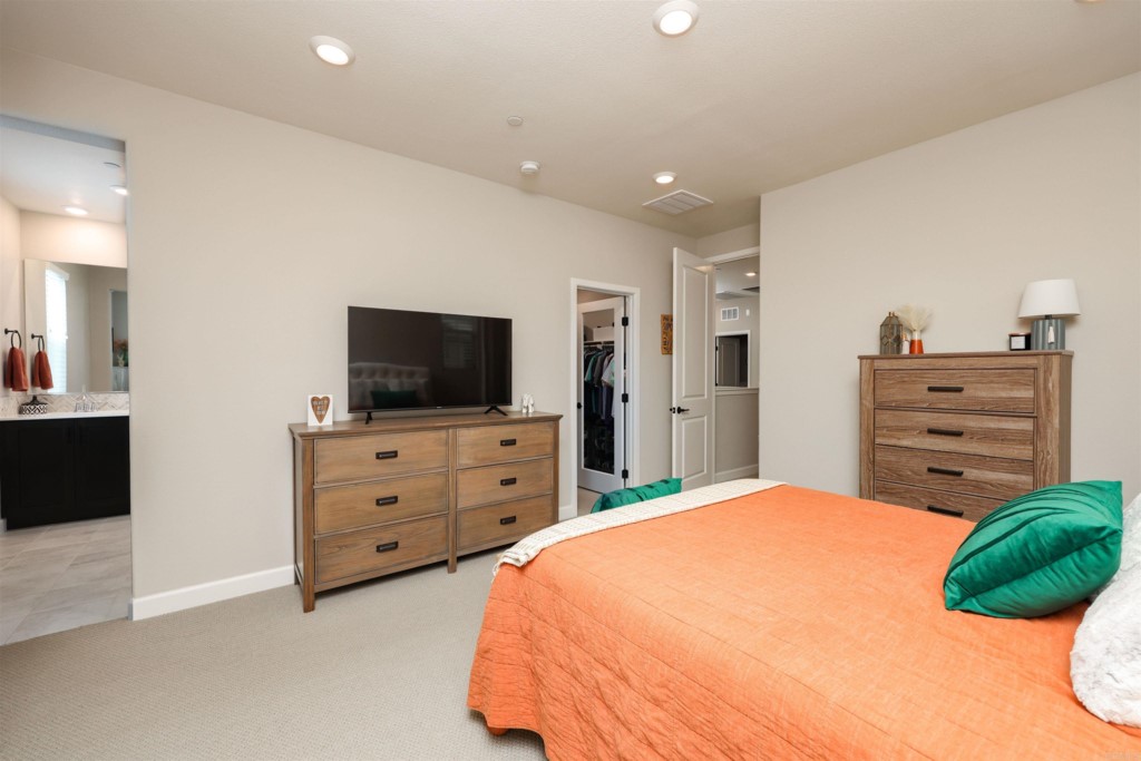 1112 Delpy View Point Vista, CA 92084 - Photo 24 of 62 a bedroom with a bed and flat screen tv