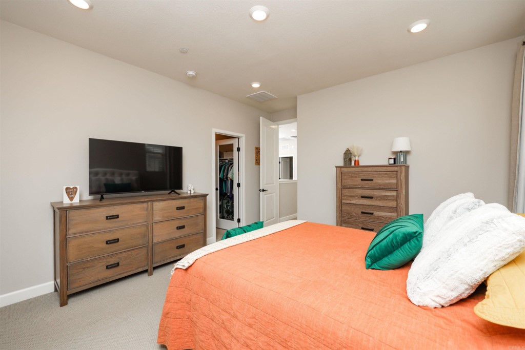 1112 Delpy View Point Vista, CA 92084 - Photo 25 of 62 a bedroom with a large bed and flat screen tv