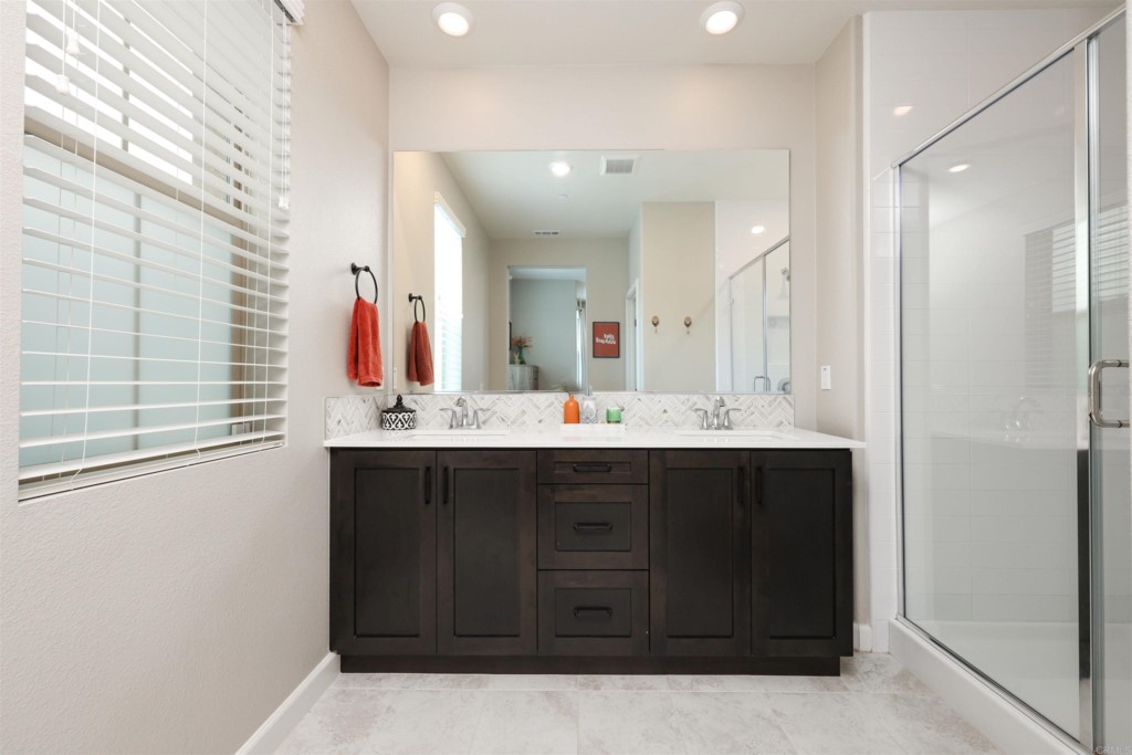 1112 Delpy View Point Vista, CA 92084 - Photo 27 of 62 a bathroom with a sink vanity and mirror
