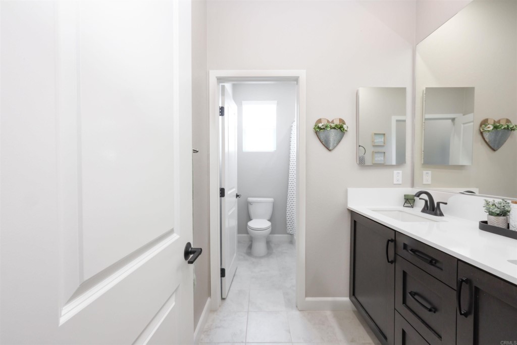 1112 Delpy View Point Vista, CA 92084 - Photo 33 of 62 a bathroom with a sink a toilet and a shower