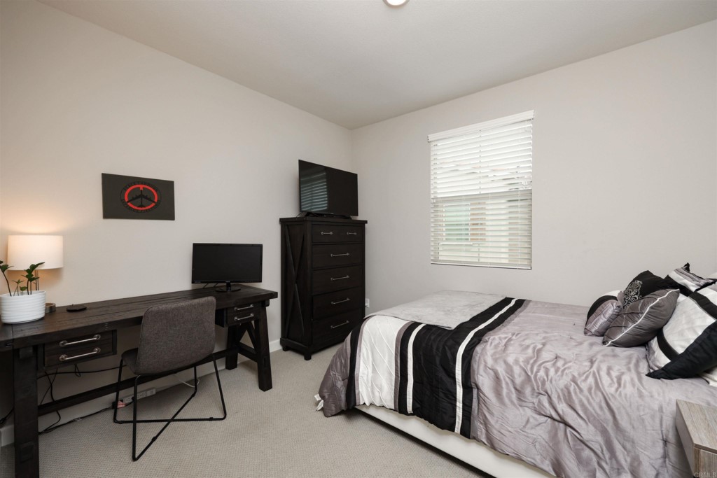 1112 Delpy View Point Vista, CA 92084 - Photo 35 of 62 a bedroom with a bed and a window