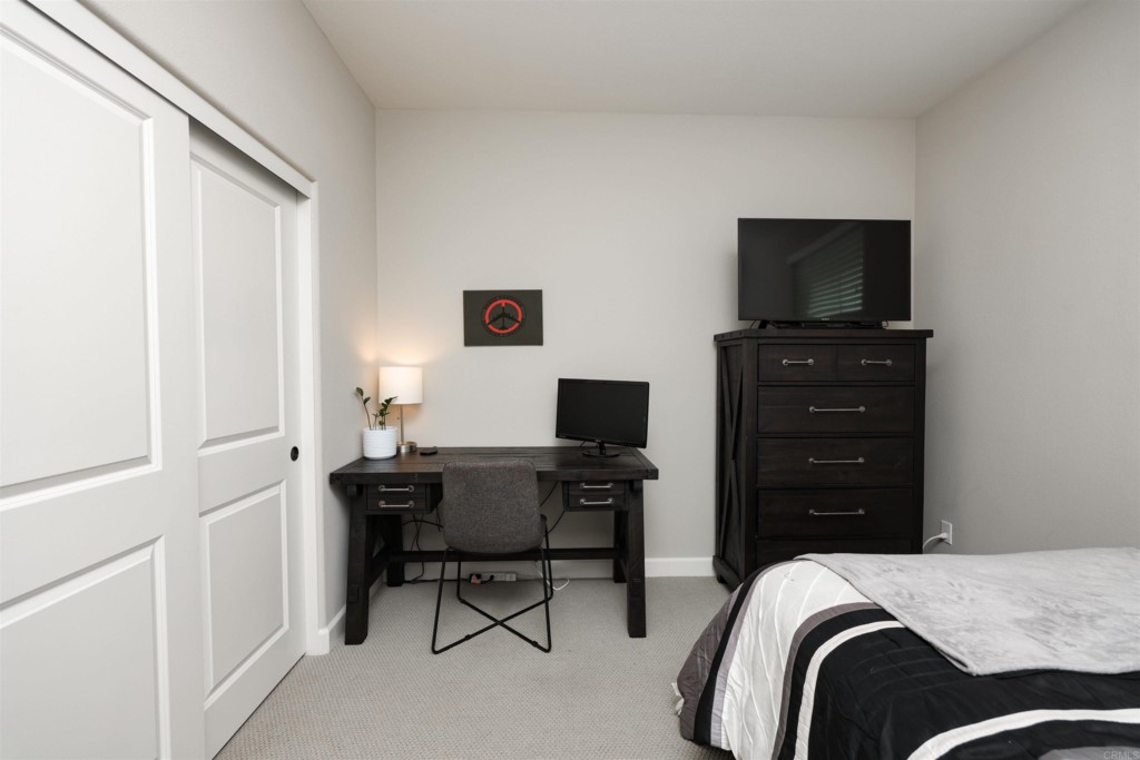 1112 Delpy View Point Vista, CA 92084 - Photo 36 of 62 a bedroom with a bed and a flat screen tv