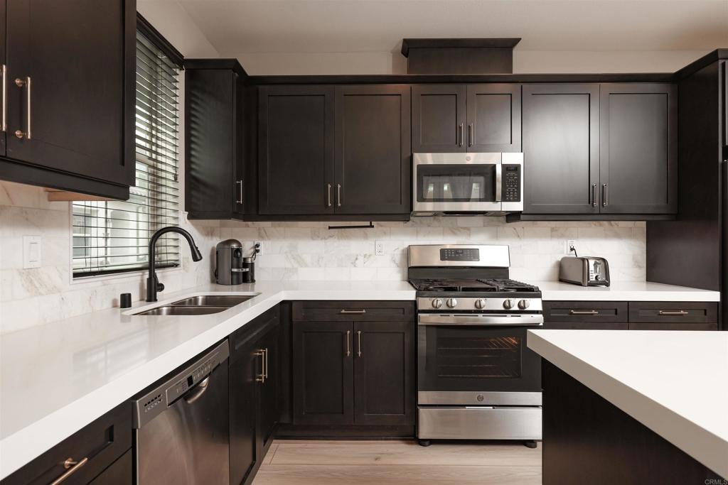 1112 Delpy View Point Vista, CA 92084 - Photo 5 of 62 a kitchen with a sink stove and microwave